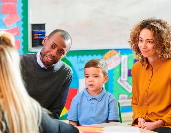 Adults and child in classroom