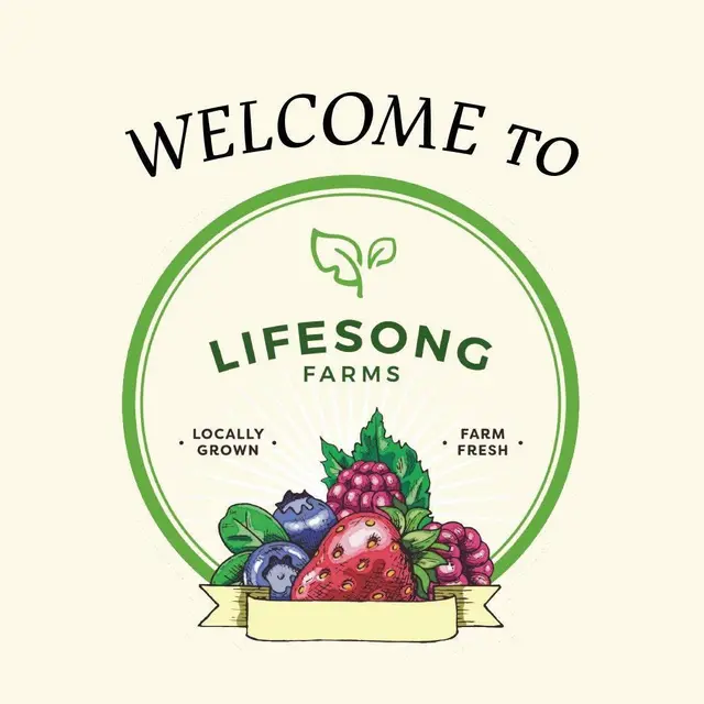 Woman in greenhouse holding strawberry