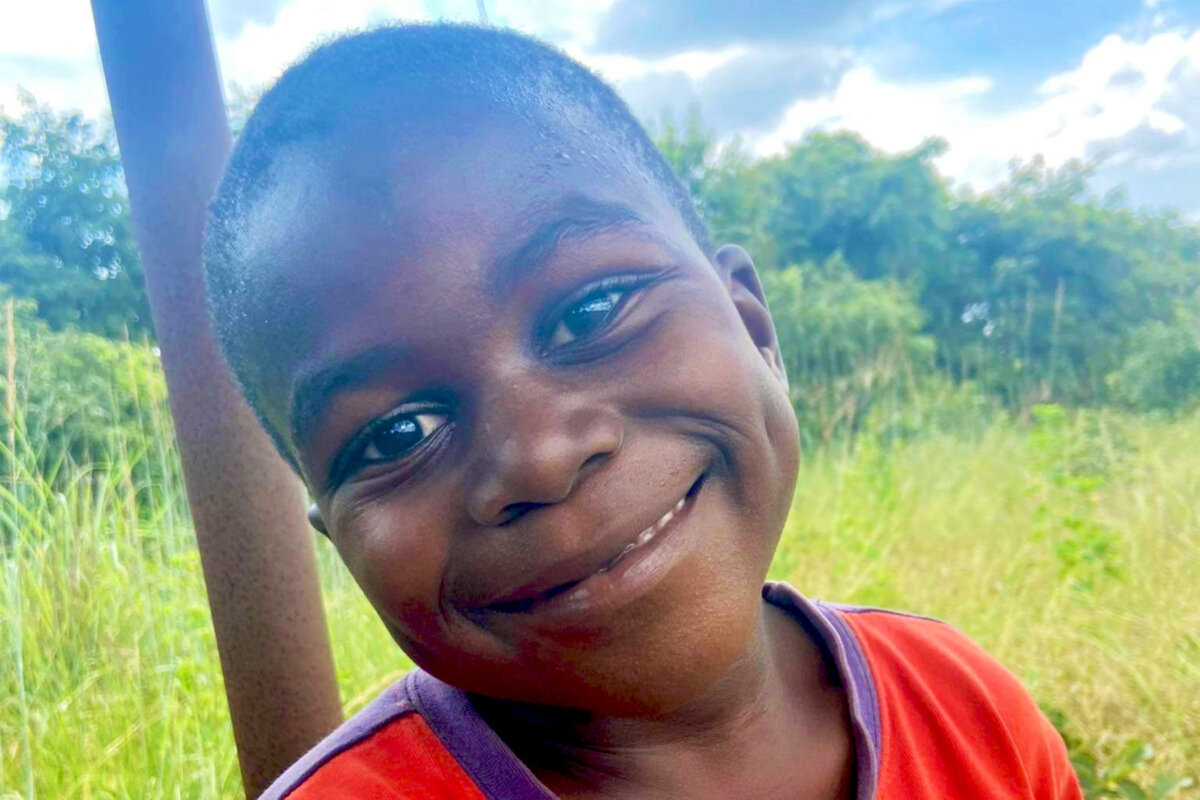 A boy smiles on the New Day campus